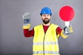 Young construction worker with hardhat stopping traffic Royalty Free Stock Photo