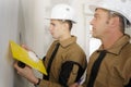 Young construction worker wall plastering