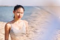 young contemplative asian female at beach