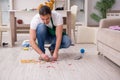 Young male contractor cleaning the flat after kids party