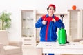 Young contractor doing pest control at home Royalty Free Stock Photo