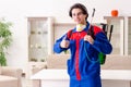 Young contractor doing pest control at home Royalty Free Stock Photo