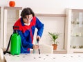 Young contractor doing pest control at home