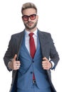 Young cool businessman arranging his coat Royalty Free Stock Photo