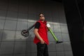 Young cool man hipster posing with electric scooter. Guy in fashionable red- black jeans clothes in sunglasses with a scooter Royalty Free Stock Photo