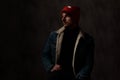 Young cool model wearing red hat and denim jacket