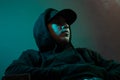 Young cool rapper with black hoodie and cap looking sideways Royalty Free Stock Photo