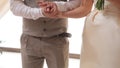 Young copule holding hands on the wedding