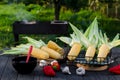 Young corn marinates on a wooden table in the garden before cooking Royalty Free Stock Photo