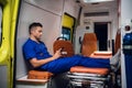 Young corpsman sits with phone in the ambulance car