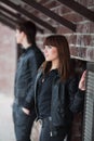 Young fashion couple flirting at the wall Royalty Free Stock Photo