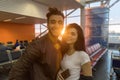 Young Couple In Airport Lounge Waiting Departure Happy Smile Hispanic Man And Woman Royalty Free Stock Photo