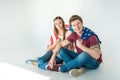 young couple with american flag sitting together and smiling at camera