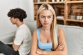 Young couple angry sitting on the sofa in silence at home