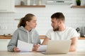 Young couple arguing about bills or document at home kitchen Royalty Free Stock Photo