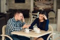 Young couple arguing in a cafe. She`s had enough, boyfriend is apologizing. Relationship problems. Royalty Free Stock Photo