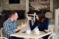 Young couple arguing in a cafe. She`s had enough, boyfriend is apologizing. Relationship problems.