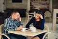 Young couple arguing in a cafe. She`s had enough, boyfriend is apologizing. Relationship problems.