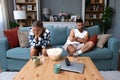 Young couple are arguing on the couch in their home and having difficulty and problems in a relationship and marriage sitting back Royalty Free Stock Photo