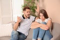 Young couple arguing in living room. Royalty Free Stock Photo