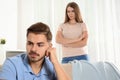 Young couple arguing in living room. Royalty Free Stock Photo