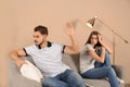 Young couple arguing in living room. Royalty Free Stock Photo