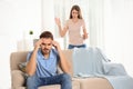 Young couple arguing in living room. Royalty Free Stock Photo