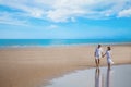 Young couple asian in love walking and holding hand together at sea beach on blue sky . happy smiling wedding with white dress Royalty Free Stock Photo