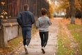Young couple, athletes, train in the autumn park, jog. Royalty Free Stock Photo
