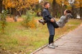 Young couple, athletes, training in an autumn park, a girl using a guy shakes a press. Royalty Free Stock Photo