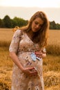 Young couple awaiting baby embrace the field Royalty Free Stock Photo