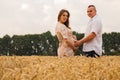 Young couple awaiting baby among the wheat field Royalty Free Stock Photo