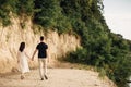 Young couple back walking near to the lake on nature. Romantic man and woman are hugging outdoors. Happy moments together. love Royalty Free Stock Photo