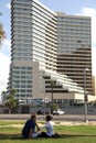 A young couple in the background of a hotel on the waterfront of Tel Aviv Royalty Free Stock Photo