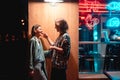 Young couple at the bar, street of the night city Royalty Free Stock Photo