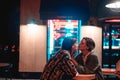 Young couple at the bar, street of the night city Royalty Free Stock Photo