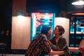 Young couple at the bar, street of the night city Royalty Free Stock Photo