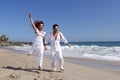 Young Couple at the beach jumping Royalty Free Stock Photo