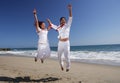 Young Couple at the beach jumping for joy Royalty Free Stock Photo