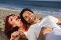 Young couple at the beach laughing Royalty Free Stock Photo