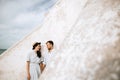 Young couple on the beach near the wall of the old lighthouse. Copispace