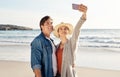 Young couple, beach selfie and happy in summer sunshine for love, romance or smile for social media post. Man, woman and Royalty Free Stock Photo