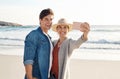 Young couple, beach selfie and smile in summer sunshine for love, romance or happy for social media post. Man, woman and Royalty Free Stock Photo