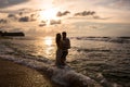 Young couple on the beach at sunset Royalty Free Stock Photo