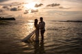 Young couple on the beach at sunset Royalty Free Stock Photo