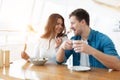 Young couple beautiful woman feeds her handsome man with salad drinking coffee in cafe during lunch break ,looking happy, Royalty Free Stock Photo