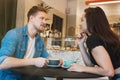 Young couple beautiful woman and handsome man drinking hot coffee in the cafe having romantic date looking happy Royalty Free Stock Photo