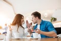 Young couple beautiful woman and handsome man fighting, having argument while drinking coffee in cafe during lunch time break, Royalty Free Stock Photo