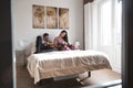 Young couple in bed entertained with book and a bunny Royalty Free Stock Photo