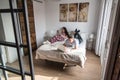 young couple in bed entertained on their computer and tablet Royalty Free Stock Photo